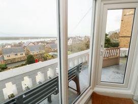 A balcony with a view of houses and water at Preswylfa Caernarfon