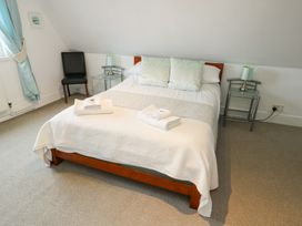 A bedroom with a bed and nightstand at Preswylfa in Caernarfon