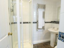 A bathroom with a shower and sink at Preswylfa in Caernarfon