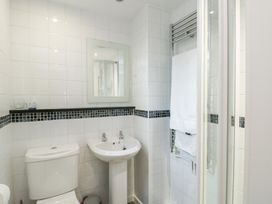 A bathroom with a toilet, sink, and shower at Preswylfa in Caernarfon