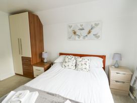 A bedroom with a bed and wardrobe at Preswylfa, Caernarfon