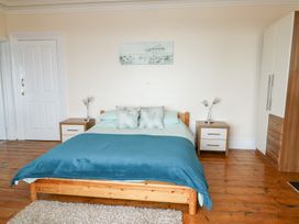 A bedroom with a bed and nightstands at Preswylfa in Caernarfon