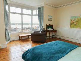 A bedroom with a view of the water at Preswylfa Caernarfon