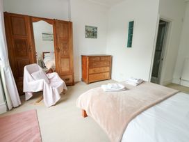 A bedroom with a bed and wardrobe at Preswylfa, Caernarfon