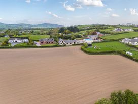 An aerial view of houses and fields at Arosfa in Axton near Trelawynd