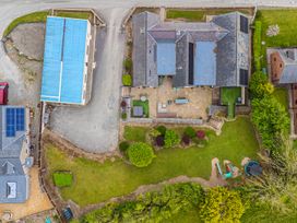 An outdoor area with a garden and patio at Arosfa in Axton near Trelawynd