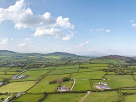 A landscape view with fields and houses at Arosfa Axton near Trelawynd