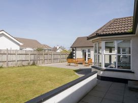 A garden with patio furniture and a lawn next to a house at SeaShells in Castlerock