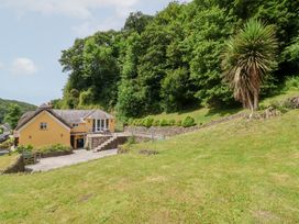 A house with a garden and trees at Old Maids Cottage in Woolacombe