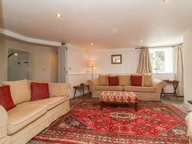 A living room with sofa and rug at Old Maids Cottage in Woolacombe