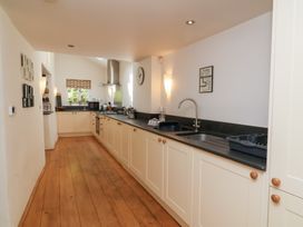 A kitchen with sink and appliances at Old Maids Cottage in Woolacombe