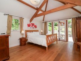 A bedroom with a bed and nightstand at Old Maids Cottage in Woolacombe