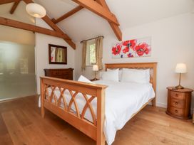 A bedroom with a bed and nightstand at Old Maids Cottage, Woolacombe
