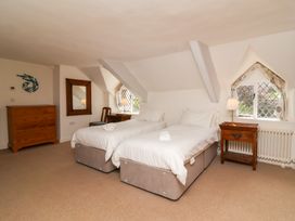 A bedroom with two single beds and a dresser at Old Maids Cottage in Woolacombe