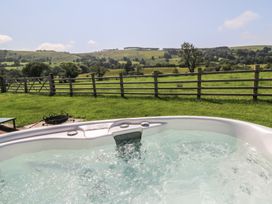 A hot tub with a view of the landscape at Bwthyn Bach Brefi
