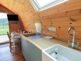 A kitchen with a sink and stove at Bwthyn Bach Brefi