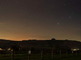 A view of a night sky with stars and hills at Bwthyn Bach Brefi