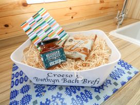 A basket with snacks and a card on a countertop at Bwthyn Bach Brefi Llanddewi-Brefi