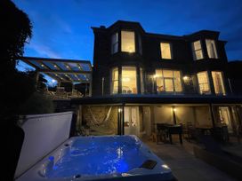 An outdoor area with a hot tub and terrace furniture at Victoria Mount in Grange-Over-Sands