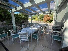 An outdoor dining area with a table and chairs at Victoria Mount in Grange-Over-Sands