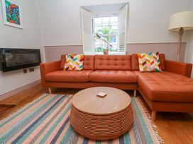 A living room with a sofa and coffee table at 21 Alverton Street Penzance