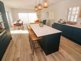 A kitchen with an island and dining table at 21 Alverton Street Penzance