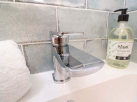 A faucet with hand soap and towel in a bathroom at 21 Alverton Street in Penzance