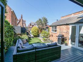 A backyard with outdoor sofa set barbecue grill and artificial grass at Royal Victoria House in Scarborough