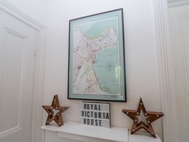 A framed map on a wall with two illuminated star decorations and a sign reading Royal Victoria House in Scarborough