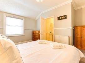 A bedroom with a bed and dresser at Royal Victoria House in Scarborough