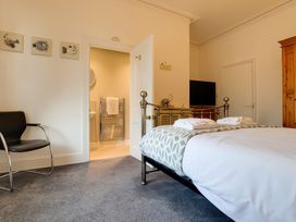 A bedroom with a bed and television at Royal Victoria House in Scarborough