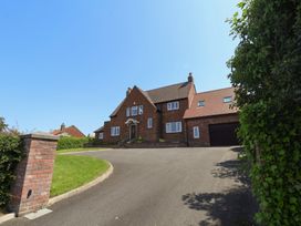 A house with a driveway and garage at 21 Eskdaleside Sleights
