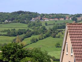 A view of houses and fields with trees on a hill at 21 Eskdaleside Sleights
