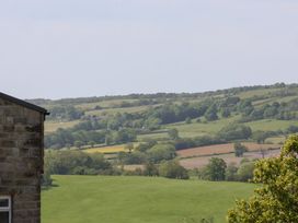 A view of hills and fields with trees and a sky at 21 Eskdaleside Sleights