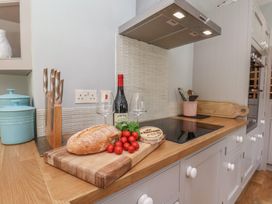 A kitchen with a cutting board and food items at 21 Eskdaleside Sleights