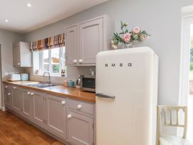 A kitchen with a refrigerator and sink at 21 Eskdaleside in Sleights