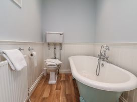 A bathroom featuring a bathtub and toilet at 21 Eskdaleside in Sleights