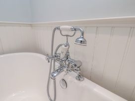 A bath tub with chrome faucet and showerhead at 21 Eskdaleside Sleights