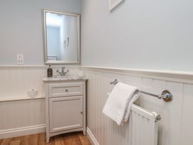 A bathroom with a sink and mirror at 21 Eskdaleside Sleights