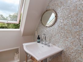 A bathroom with a sink and mirror at 21 Eskdaleside in Sleights