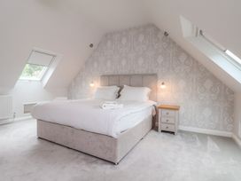 A bedroom with a bed and bedside table at 21 Eskdaleside, Sleights