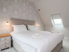 A bedroom with a bed and bedside table at 21 Eskdaleside in Sleights