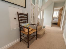 A hallway with a chair and stairs at 21 Eskdaleside Sleights