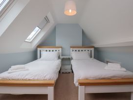 A bedroom with two beds and a nightstand at 21 Eskdaleside in Sleights