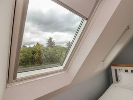 A bedroom window showing trees and clouds at 21 Eskdaleside Sleights