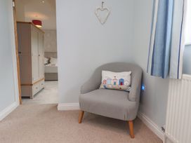 A bedroom with an armchair and wardrobe at 21 Eskdaleside Sleights