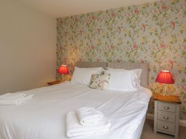 A bedroom with a bed and nightstand at 21 Eskdaleside Sleights