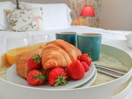 A breakfast tray with pastries and drinks at 21 Eskdaleside Sleights