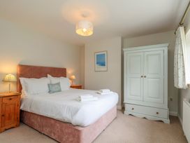 A bedroom with a bed and wardrobe at 21 Eskdaleside Sleights