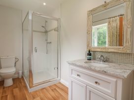 A bathroom with a shower, toilet, and sink at 21 Eskdaleside in Sleights